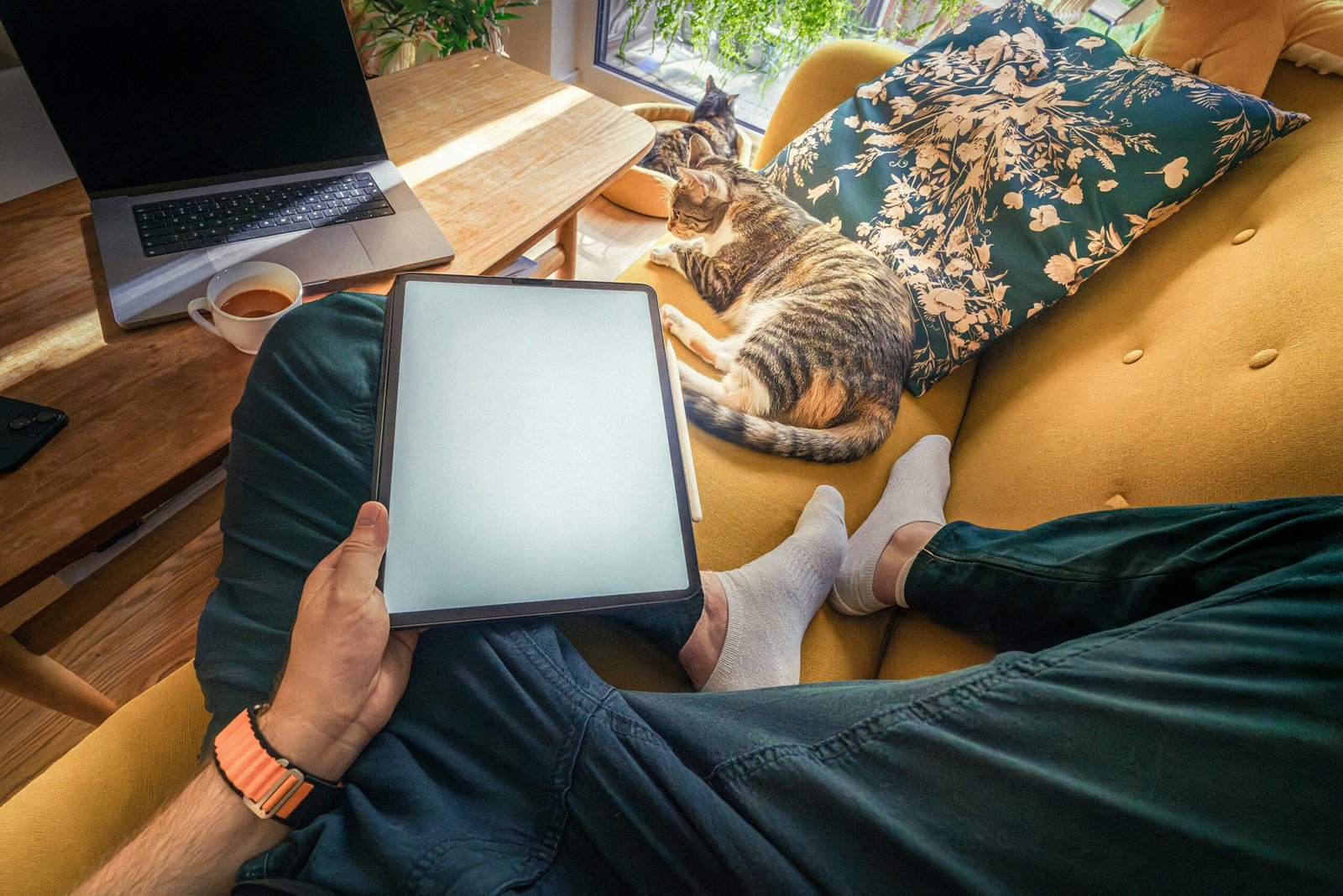 A person sitting on a couch with a tablet